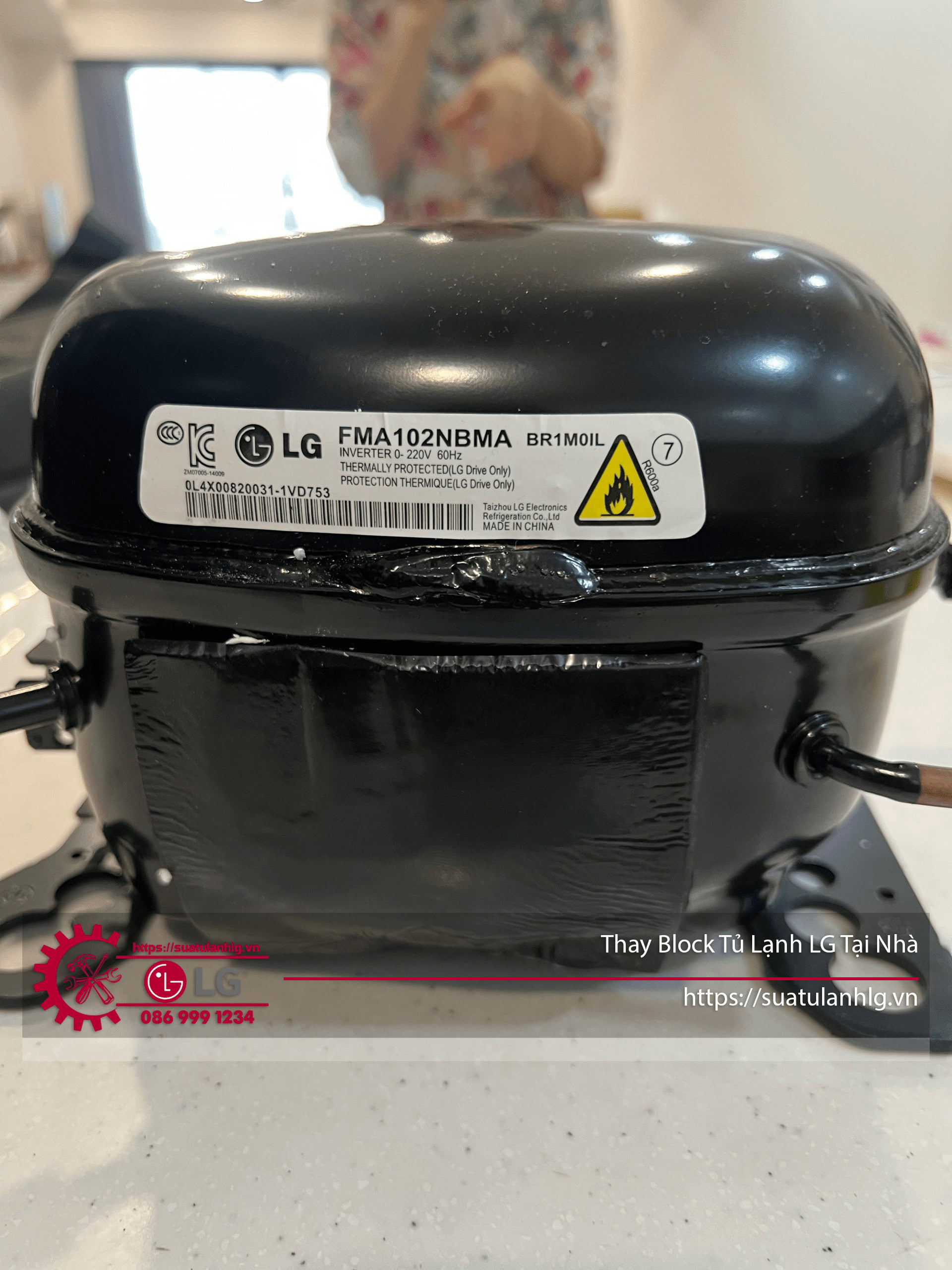 Refrigeration compressor LG with warranty tag, used for cooling appliances, in black color.